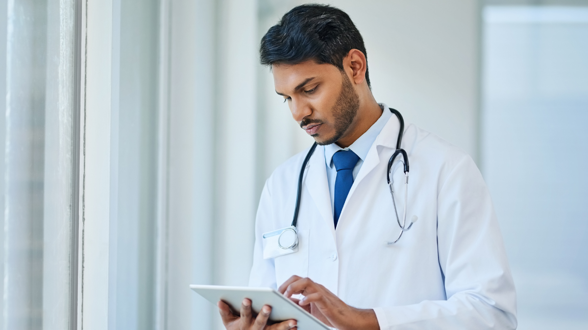 Physician looking at a clipboard.