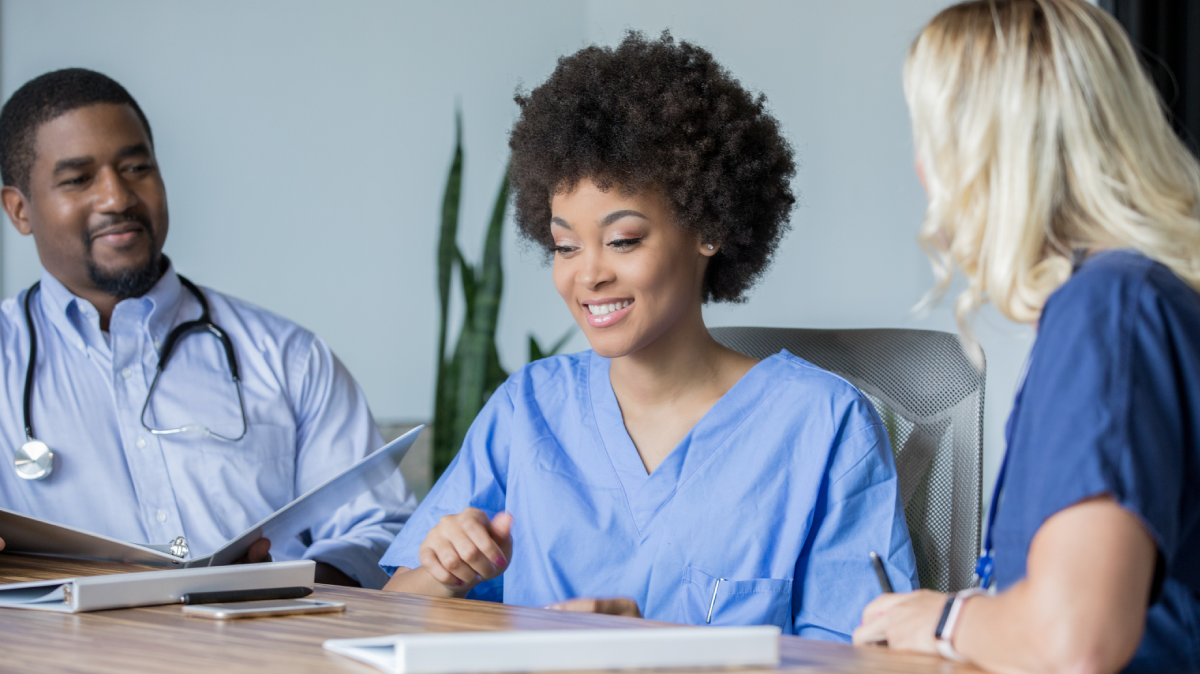 people sitting in a hospital boardroom