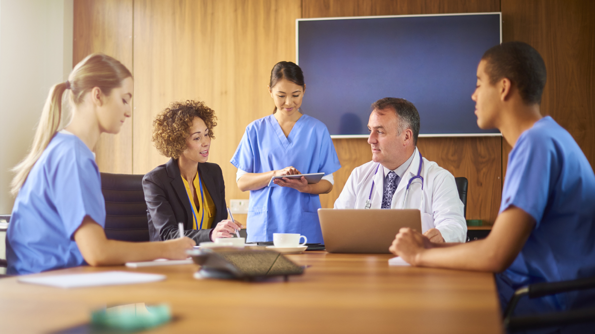 Hospital staff sitting in a boardroom.