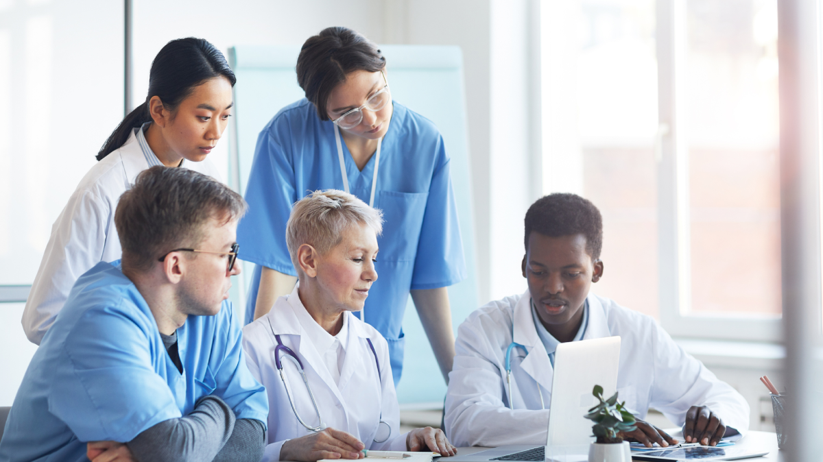 A group of healthcare professionals reviewing data on a computer