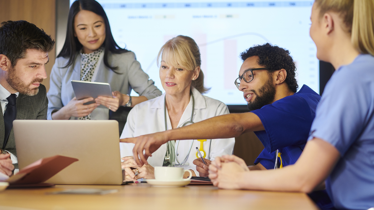 Hospital executives and leaders reviewing data analytics.